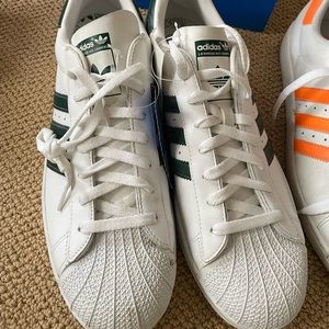 Class is Adidas mens Superstar sneakers. New with tags!  Dark green